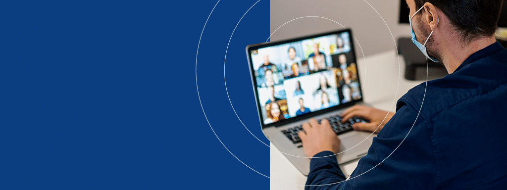 A man wearing a mask participates in a virtual meeting on his laptop, discussing innovative solutions like Wayleadr for efficient parking management systems, with multiple participants visible on the screen.