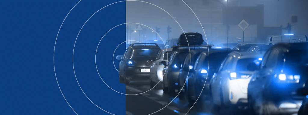 A congested city street at night with multiple cars in traffic, featuring a blue overlay with concentric circles on the left side and streamlined parking management solutions highlighted by Wayleadr.