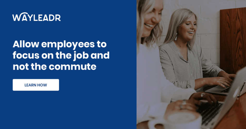 Two people are smiling and working on laptops at a desk next to text that reads, "Allow employees to focus on the job and not the commute with Wayleadr's parking lot management solutions. WAYLEADR. LEARN HOW.