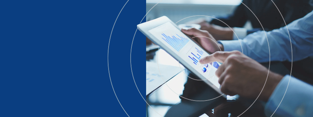 Person using a tablet displaying graphs in a business meeting, with hands of other individuals visible. The discussion focuses on innovative parking lot management solutions. Blue background on the left side of the image.